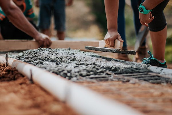 Construction project supervisor reviewing plans on a Sydney building site — CPC50320 Diploma of Building and Construction Management Wyatt Education Group